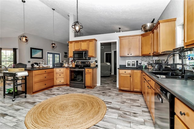 kitchen with lofted ceiling, sink, stainless steel electric range, black dishwasher, and pendant lighting