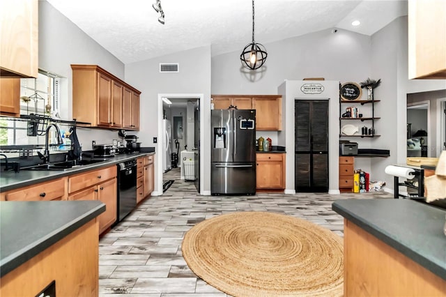 kitchen featuring stainless steel fridge with ice dispenser, vaulted ceiling, sink, and dishwasher