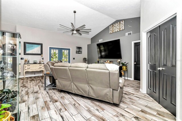 living room featuring ceiling fan and vaulted ceiling