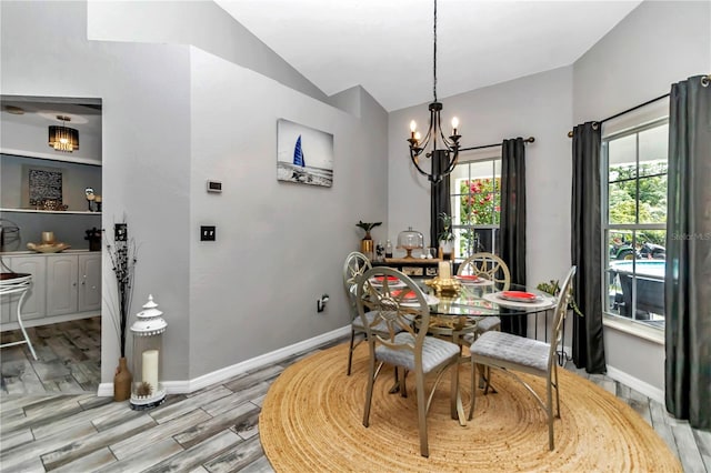 dining area featuring lofted ceiling, an inviting chandelier, and light wood-type flooring