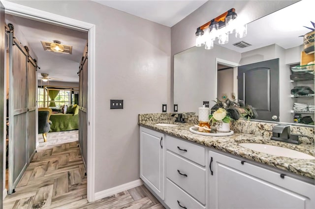 bathroom featuring ceiling fan, parquet flooring, and vanity