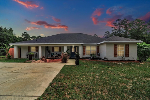 ranch-style home featuring a yard