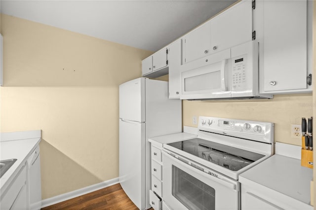 kitchen featuring dark hardwood / wood-style flooring, white cabinets, and white appliances