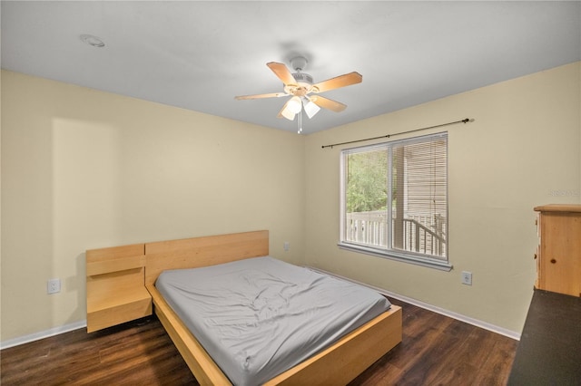 bedroom with dark wood-type flooring and ceiling fan