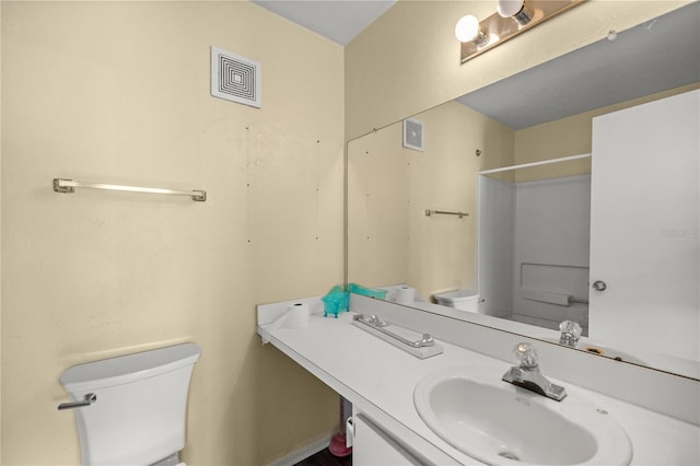 bathroom with walk in shower, vanity, and toilet