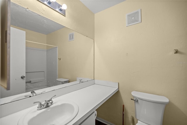 bathroom featuring vanity and toilet