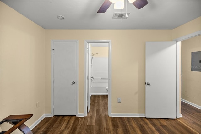 unfurnished bedroom featuring electric panel, dark hardwood / wood-style floors, and ceiling fan