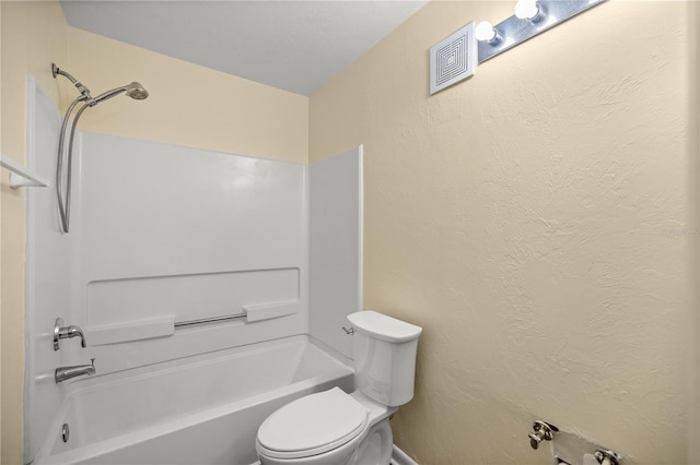 bathroom with tub / shower combination and toilet