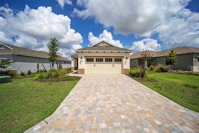 view of front of house with a garage and a front lawn