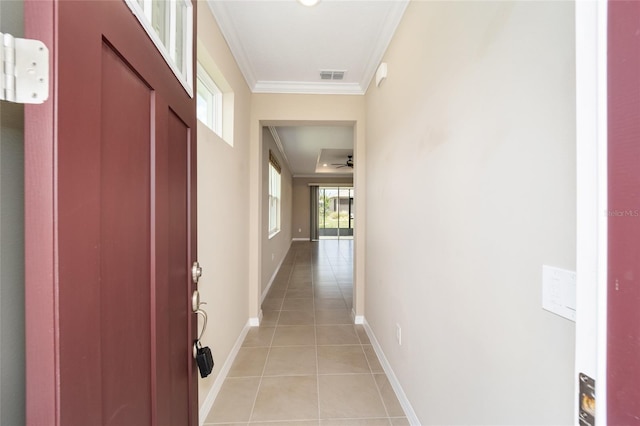 corridor featuring crown molding and light tile patterned flooring