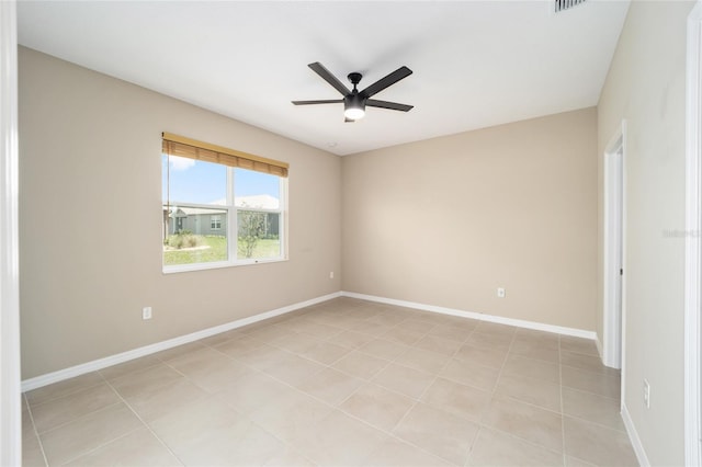 tiled empty room featuring ceiling fan