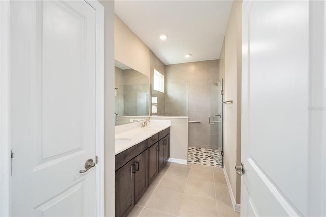 bathroom with tile patterned floors, vanity, and an enclosed shower