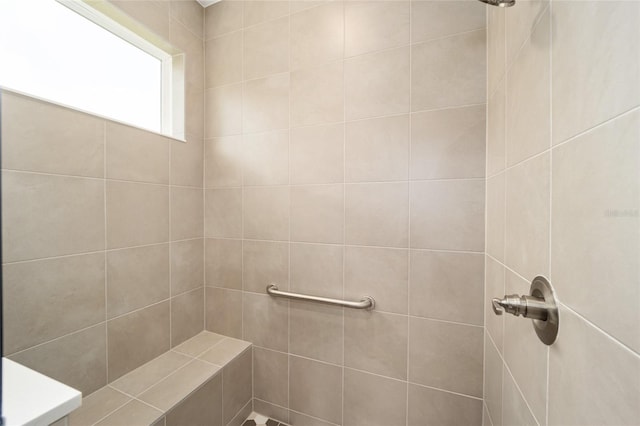 bathroom with a tile shower