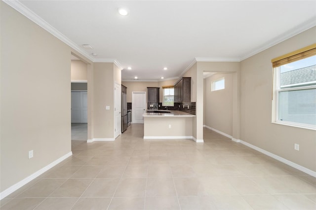 interior space with crown molding, light tile patterned flooring, and a healthy amount of sunlight