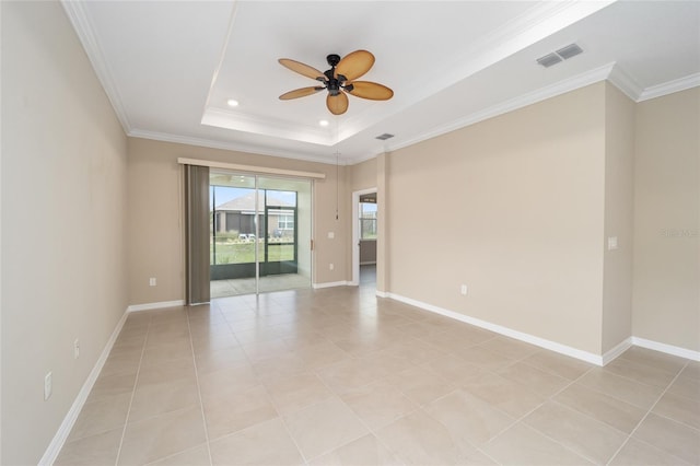 tiled spare room with a tray ceiling, crown molding, and ceiling fan