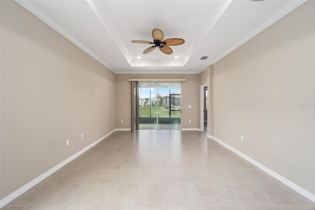 spare room featuring ceiling fan, a raised ceiling, light tile patterned floors, and crown molding