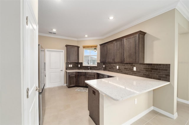 kitchen with sink, light stone counters, kitchen peninsula, a breakfast bar area, and light tile patterned floors