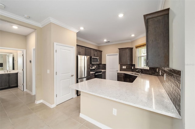 kitchen featuring sink, kitchen peninsula, light tile patterned floors, dark brown cabinetry, and stainless steel appliances