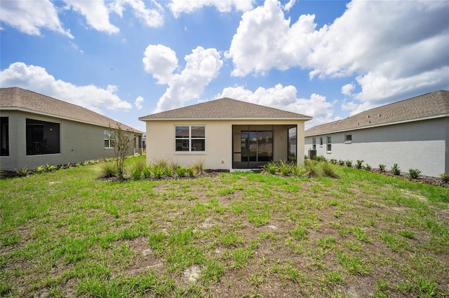 back of house featuring a yard