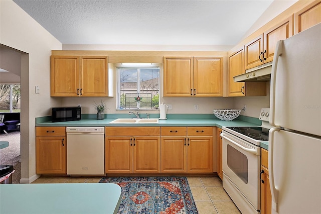 kitchen featuring a textured ceiling, white appliances, sink, and light tile patterned floors