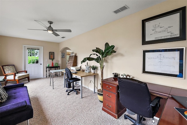 carpeted office space with ceiling fan