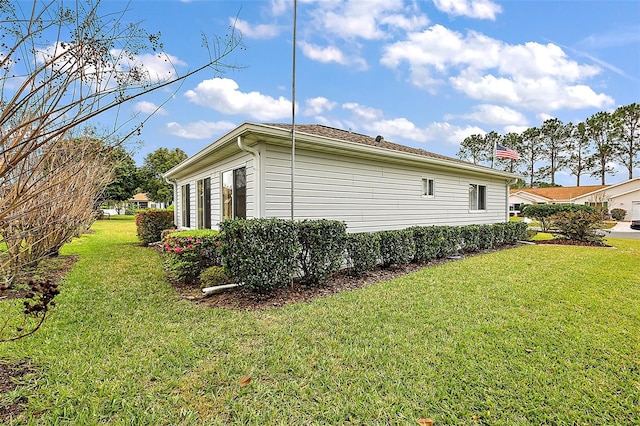 view of side of home featuring a lawn