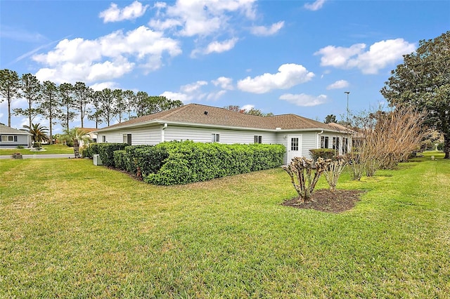 view of property exterior with a yard