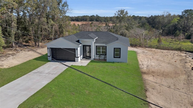 view of front of property featuring a front lawn and a garage