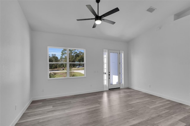 unfurnished room featuring plenty of natural light, ceiling fan, and light hardwood / wood-style flooring