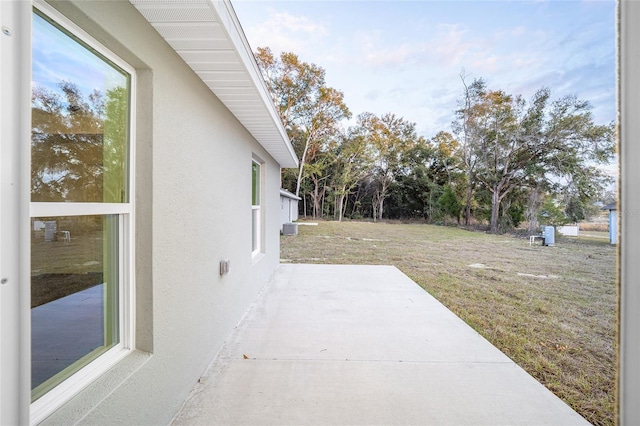 view of yard featuring cooling unit and a patio