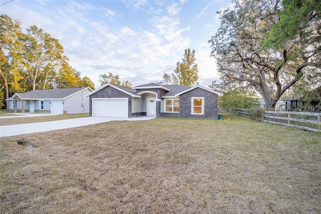 ranch-style house featuring a garage and a front lawn