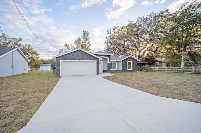 view of front of property featuring a front yard and a garage