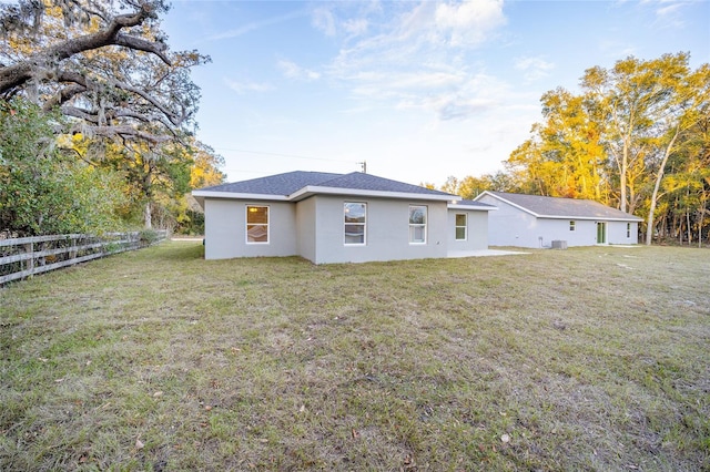 rear view of property with a yard