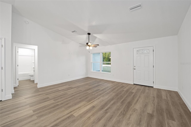 unfurnished living room with vaulted ceiling, ceiling fan, and light hardwood / wood-style floors