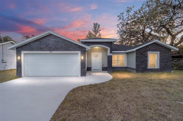 single story home with a garage and a lawn