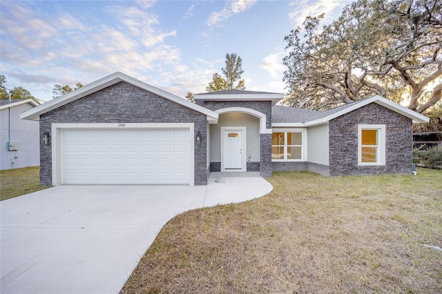 single story home featuring a front yard and a garage