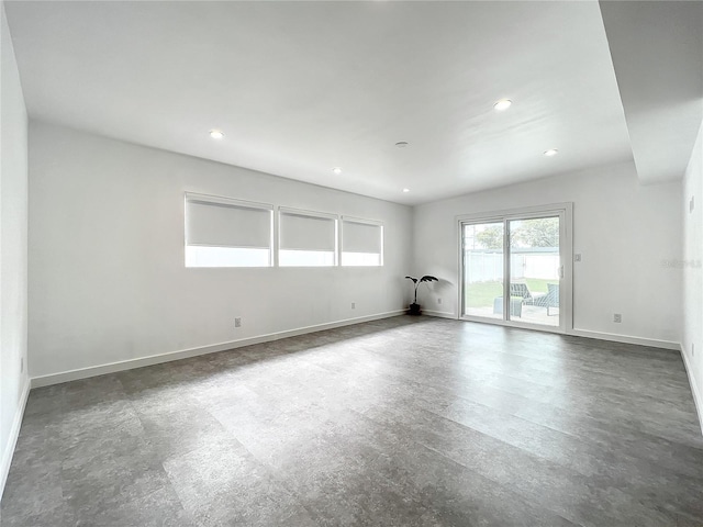 unfurnished room with recessed lighting and baseboards