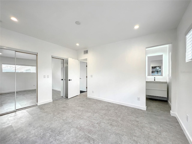 unfurnished bedroom with visible vents, baseboards, two closets, and recessed lighting