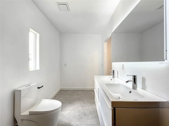 bathroom with double vanity, baseboards, toilet, and a sink