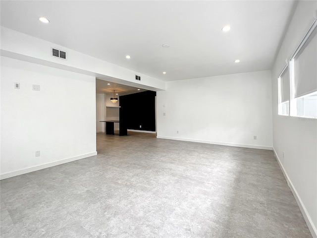 unfurnished room with baseboards, visible vents, and recessed lighting