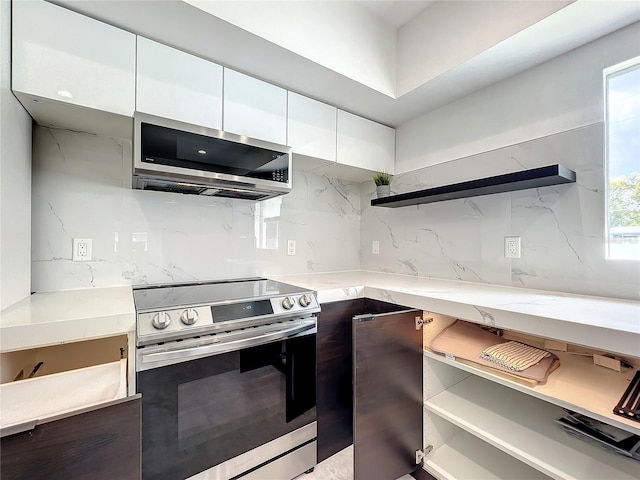 kitchen with open shelves, modern cabinets, appliances with stainless steel finishes, and white cabinets