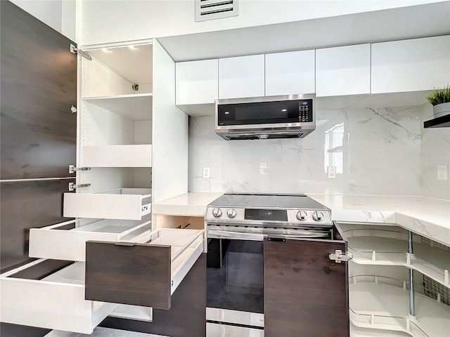 kitchen featuring stainless steel appliances, visible vents, white cabinetry, open shelves, and modern cabinets