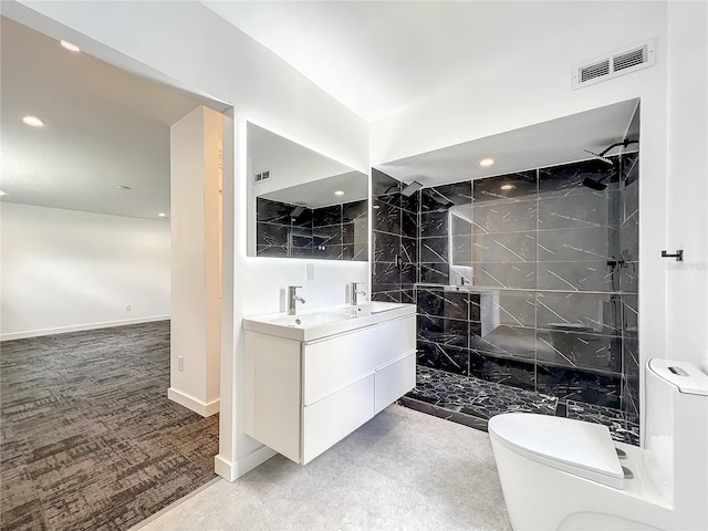 full bath with toilet, double vanity, visible vents, and a walk in shower