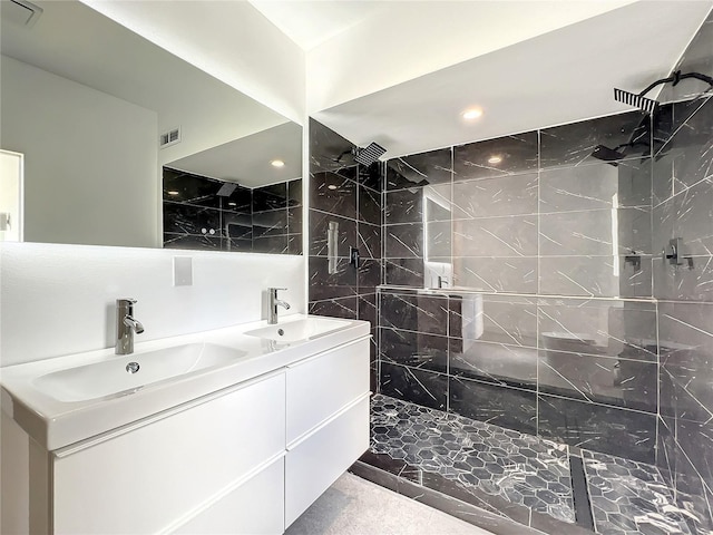 bathroom with double vanity, a sink, and visible vents