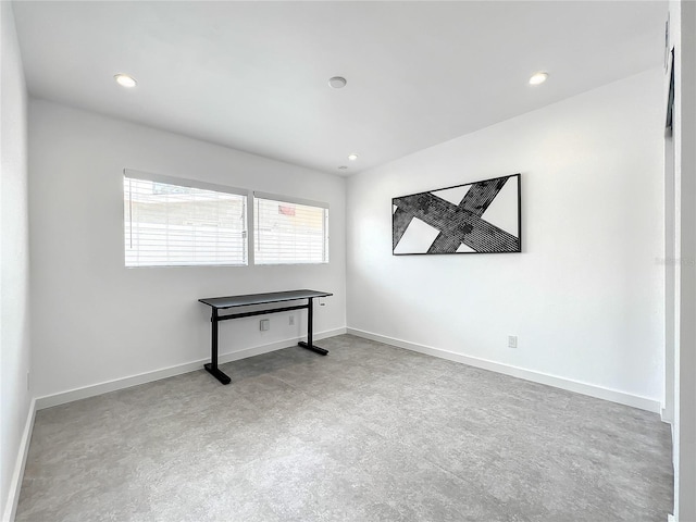 unfurnished room with recessed lighting and baseboards