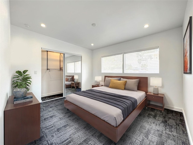 bedroom featuring baseboards, a closet, and recessed lighting