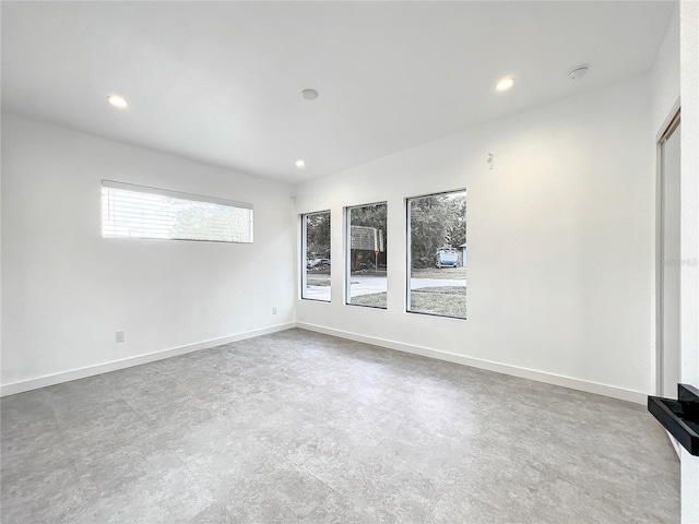 unfurnished room with baseboards, concrete flooring, and recessed lighting