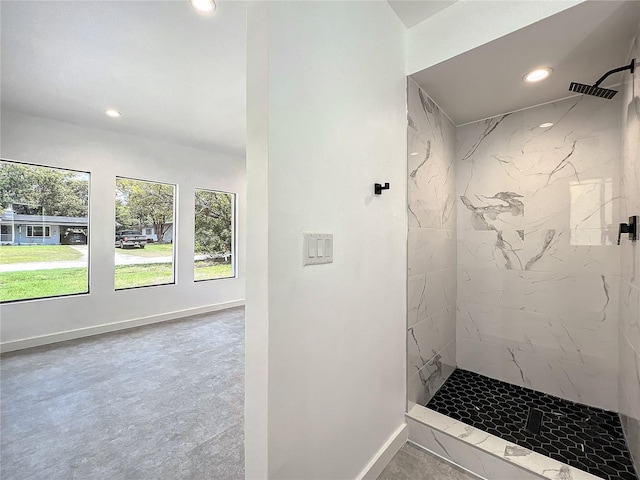 bathroom featuring recessed lighting, baseboards, and a marble finish shower