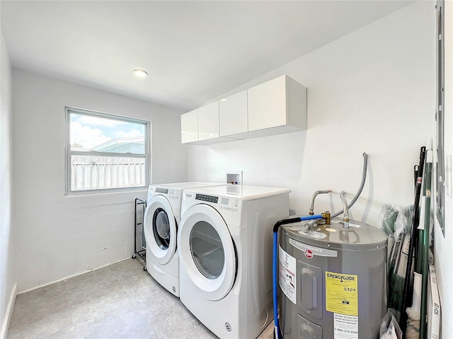 washroom featuring cabinet space, water heater, and independent washer and dryer