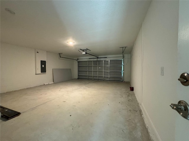 garage with a garage door opener and electric panel